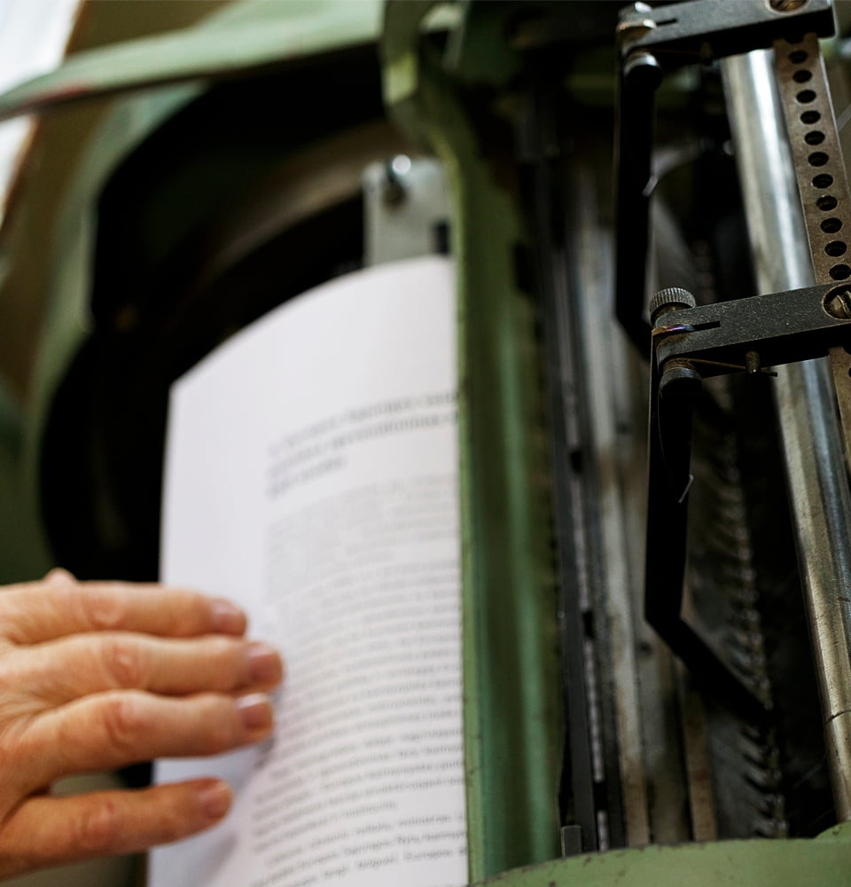 Printed book held in hand